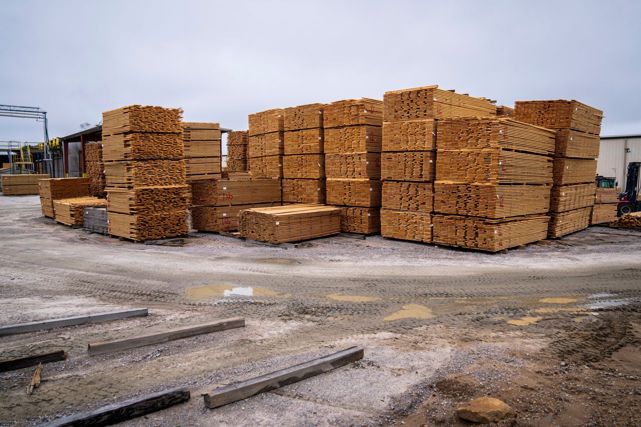 portfolio-03 Piles of wooden planks prepared for distribution in an outdoor industrial site.