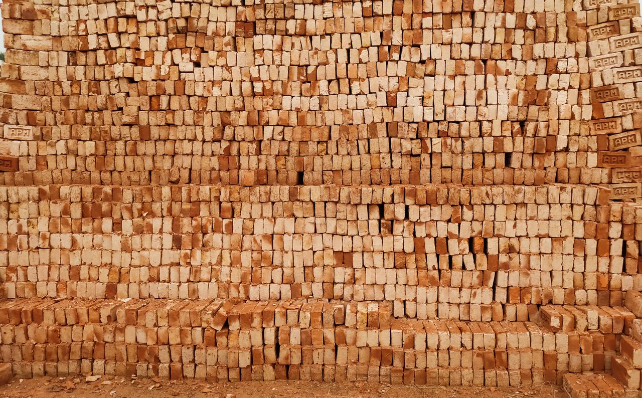 why-choose-us A close-up view of a stack of red bricks, ideal for construction and building materials imagery.