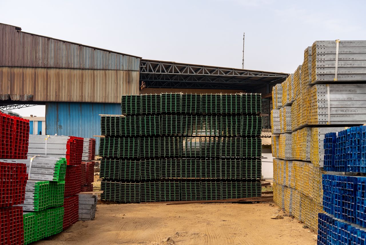 portfolio-02 Colorful stacks of industrial materials organized in an outdoor yard, showcasing vibrant organization.
